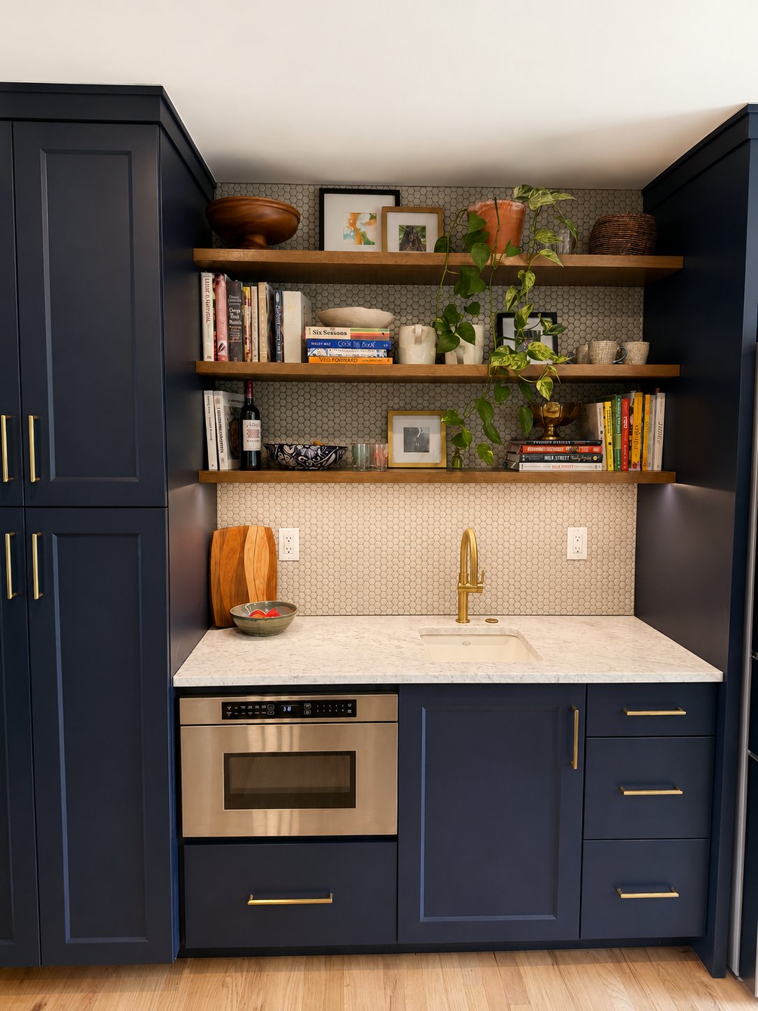 Navy kitchenette with brass hardware and open shelving